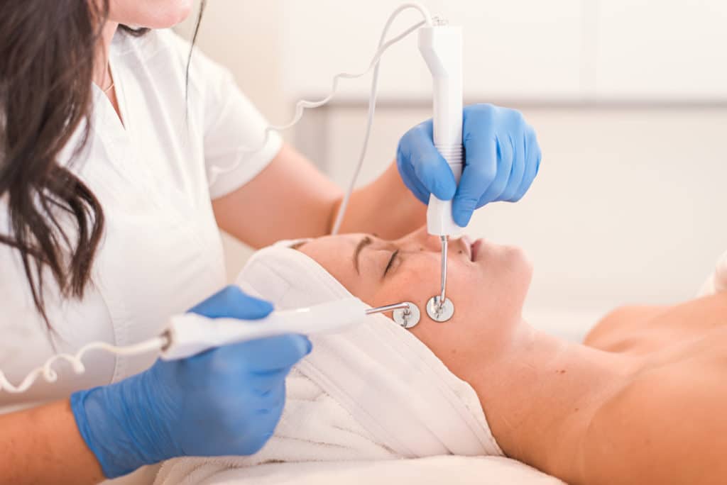 Person receiving a microcurrent facial non invasive facelift
